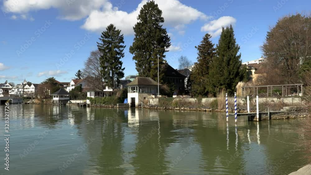 quiet lake in zurich, switzerland. lakeside buildings and beach quiet lake in zurich, switzerland. lakeside buildings and beach