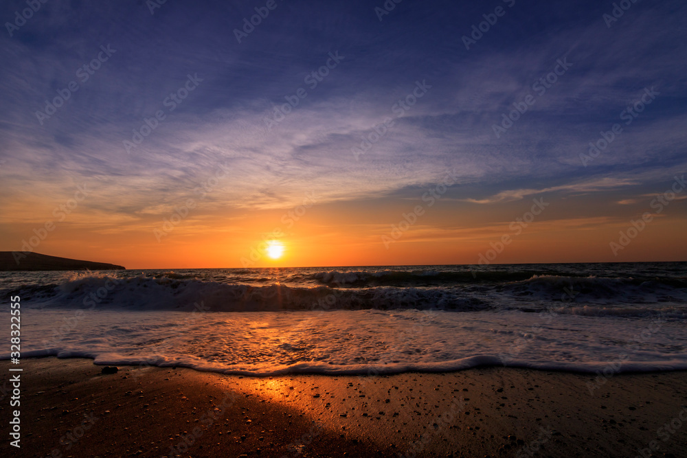 Sunset or sunrise at the sea.  beautifully photographed with sunlight and waves on the beach