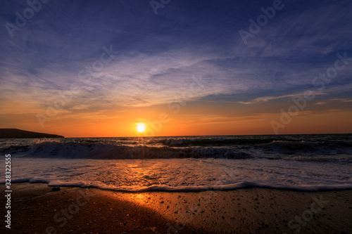 Sunset or sunrise at the sea. beautifully photographed with sunlight and waves on the beach