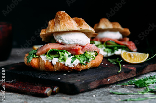 Croissant with salmon, cream cheese, poached egg and lettuce