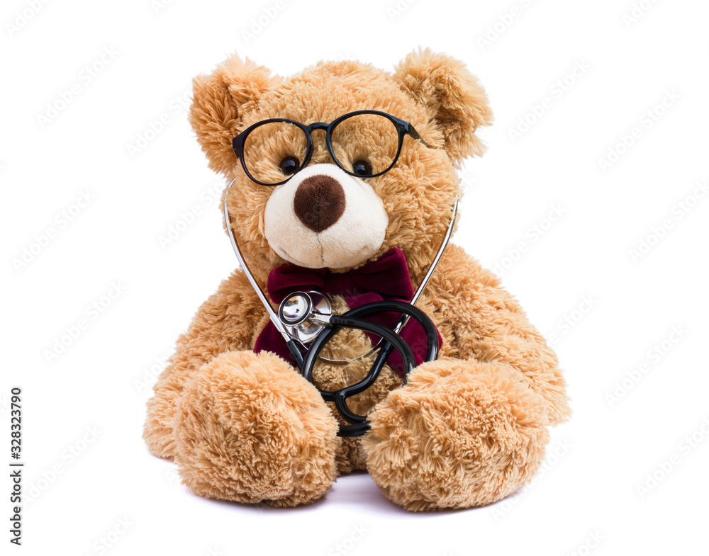 Brown doctor teddy bear with eye glasses and medical stethoscope isolated on white background.