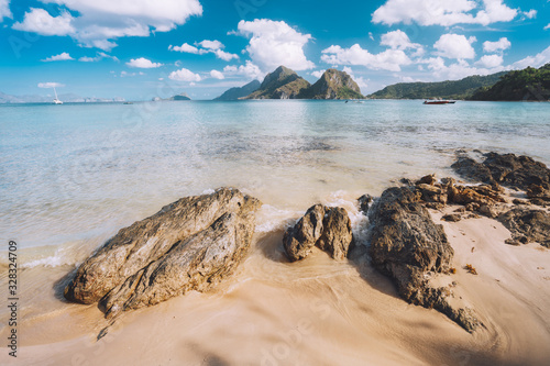 Sandy Beach with rocks and mountains in Background, El Nido, Palawan, Philippines photo