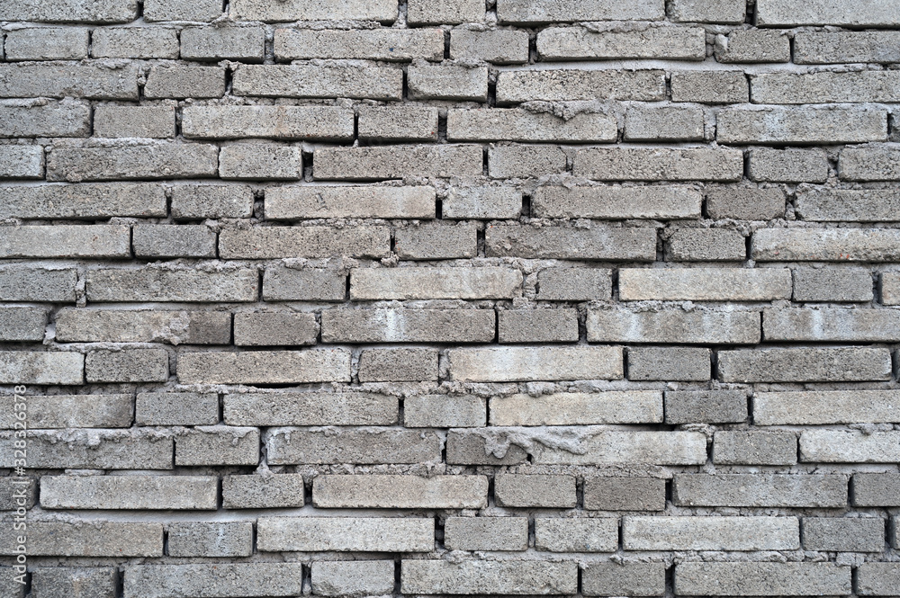 Obraz premium Rough dark gray building brick wall background