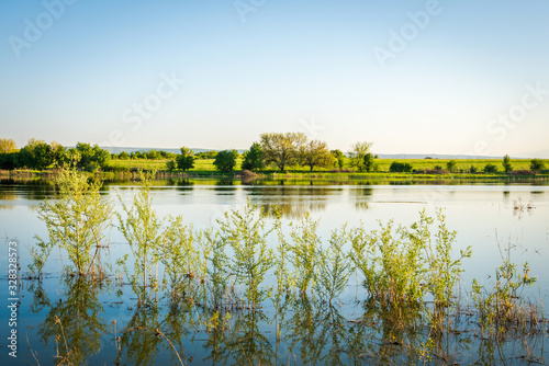 Beautiful lake landscape during spring. Countryside photo.