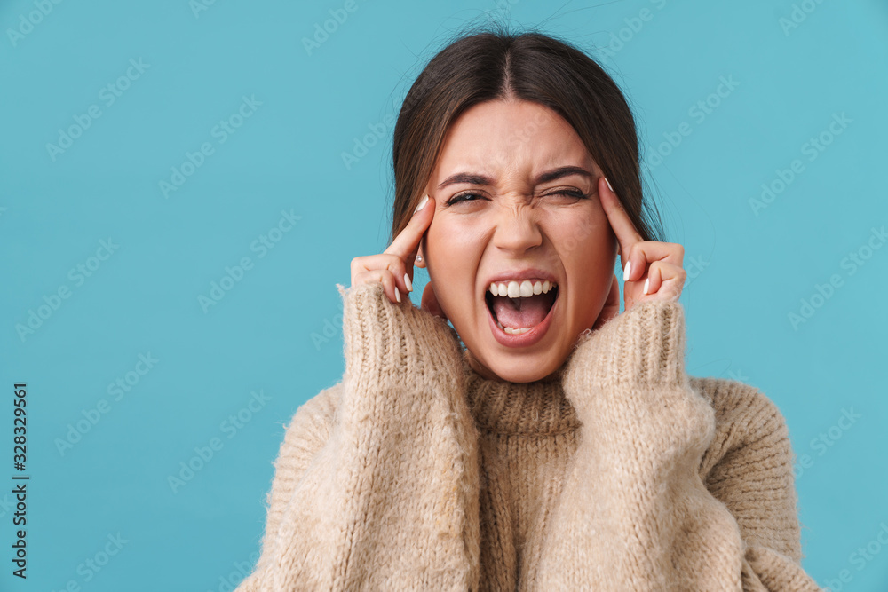 Image of annoyed woman with headache screaming and rubbing her temples Image of annoyed woman with headache screaming and rubbing her temples