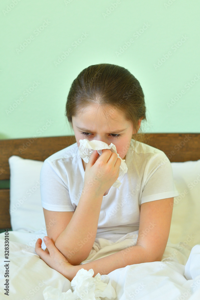 Little child girl blow his nose.Sick child with napkin in bed. Allergic kid, flu season. Kid with cold rhinitis, get cold snot nose. virus and infection Little child girl blow his nose.Sick child with napkin in bed. Allergic kid, flu season. Kid with cold rhinitis, get cold snot nose. virus and infection