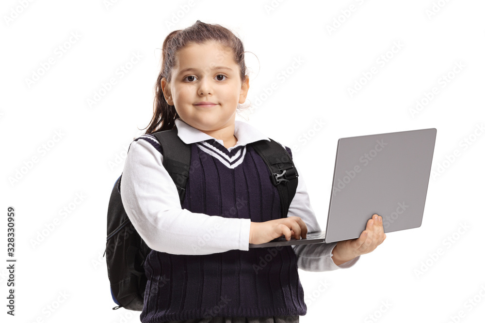 Schoolgirl in a uniform holding a laptop computer and posing
