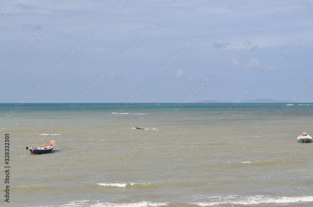 Fishing boat anchor near beach with blue sky background Fishing boat anchor near beach with blue sky background