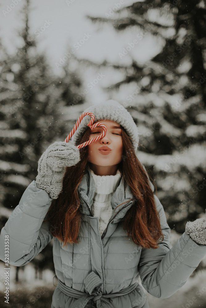 Girl in the winter forest with a cane. Girl in the winter forest with a cane.