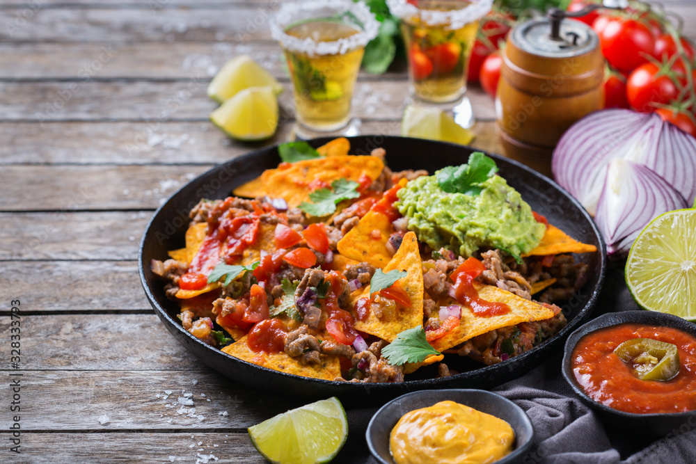Chips nachos with beef, guacamole, chili, cheese salsa, tequila Chips nachos with beef, guacamole, chili, cheese salsa, tequila