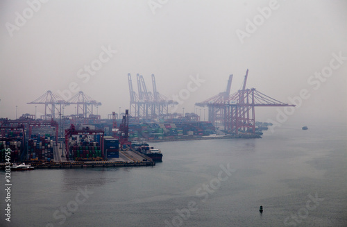 modern cranes in Port of Shenzhen in evening mist photo