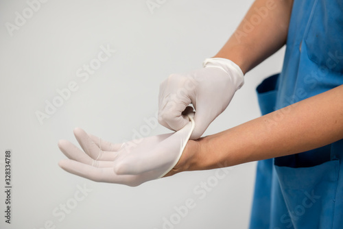 Medical personnel are wearing gloves to prevent infection in the hospital.