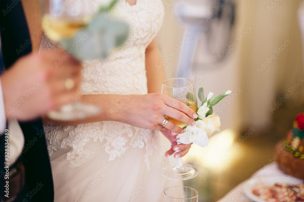 Bride in a classic white dress hold a glass of champagne Bride in a classic white dress hold a glass of champagne