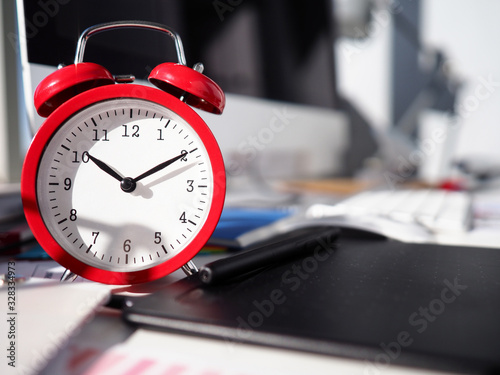 Alarm clock is on desktop, close-up watch dial