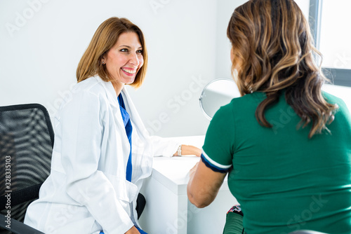Consultation in cosmetology clinic. Female doctor talking with patient