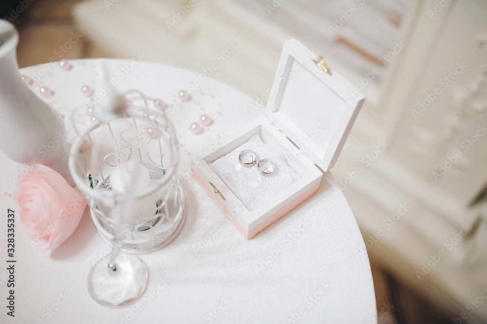 wedding rings in a wooden white box on a beautifully decorated table wedding rings in a wooden white box on a beautifully decorated table