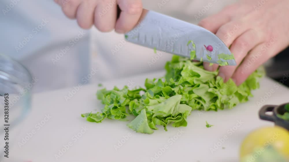 chef cutting green salad with knife chef cutting green salad with knife
