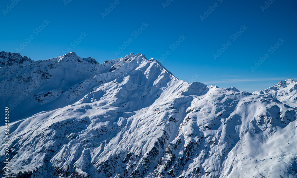European winter sports Alps - snowy peaks, mountains and ski slopes with blue skies near St. Anton am Arlberg