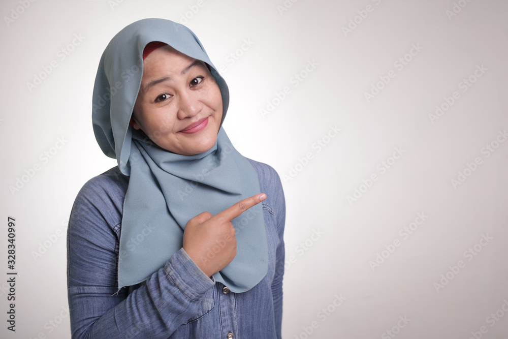 Muslim Lady Presenting Something on Her Side with Copy Space Muslim Lady Presenting Something on Her Side with Copy Space