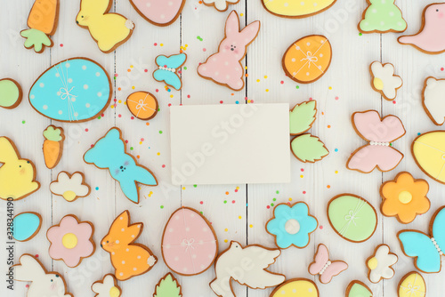 Easter card with gingerbread cookies. Easter card template. Egg shaped cookies and easter bunny. Happy easter holiday background concept. Flat lay. Copy space.