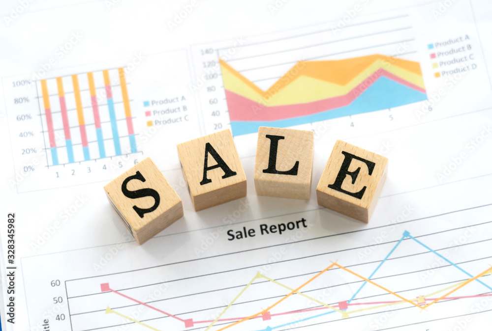 Sale alphabet in wooden cube with charts and sale report graphs. The graphs show the forecast and performance to sell the product Sale alphabet in wooden cube with charts and sale report graphs. The graphs show the forecast and performance to sell the product