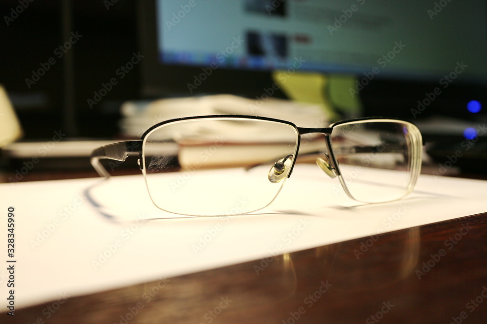 Glasses are on the office desk. Glasses are on the office desk.