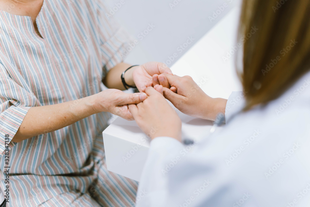 close up doctor hold hand of  senior patient  , medical care responsibility