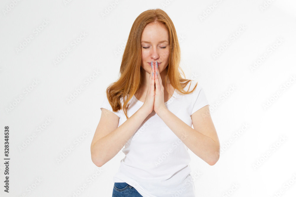 Close up portrait of beautiful Caucasian red hair girl praying isolated against white background. Red head woman with red hair and healthy freckled skin, holding hands in prayer, hoping for the best Close up portrait of beautiful Caucasian red hair girl praying isolated against white background. Red head woman with red hair and healthy freckled skin, holding hands in prayer, hoping for the best