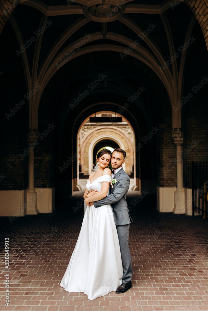 The couple standing in the middle of the corridor tunnel The couple standing in the middle of the corridor tunnel