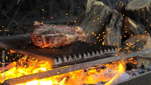 Beef steak is cooked on grill with sparks. Beef Rib BBQ