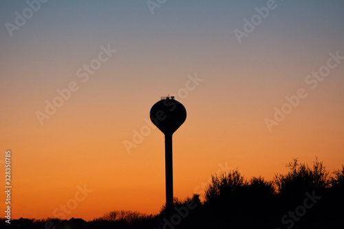 silhouette of a water tower at sunset