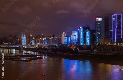 Chungking reflected in calm Jialing river in China 