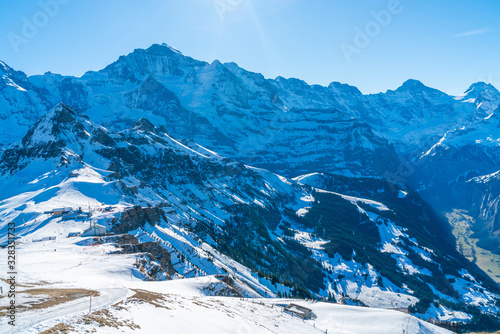 Parnoramic view of snow covered Swiss Alps from Mannlichen mountain in Grindelwald ski resort. Winter in Switzerland