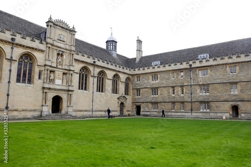 Courtyard of Oxford University. Beautiful historical building with green lawn. 