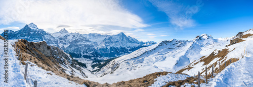 Wide parnoramic view of snow covered Swiss Alps in Grindelwald ski resort, Switzerland photo