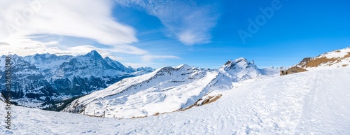 Wide parnoramic view of snow covered Swiss Alps from Mannlichen mountain in Grindelwald ski resort, Switzerland © beataaldridge