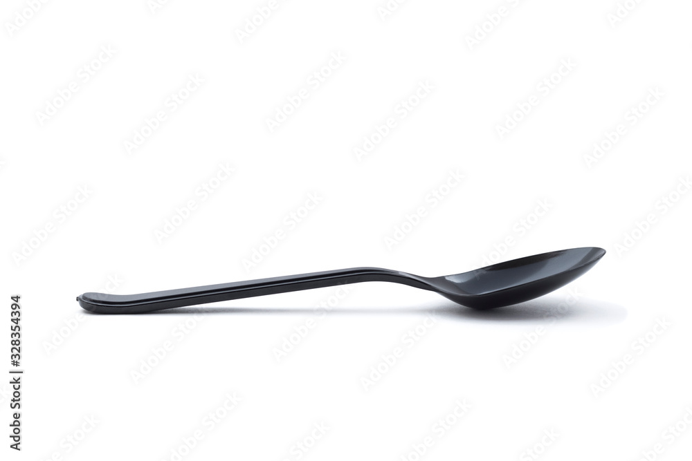 Single small black plastic baby teaspoon isolated from white background Single small black plastic baby teaspoon isolated from white background