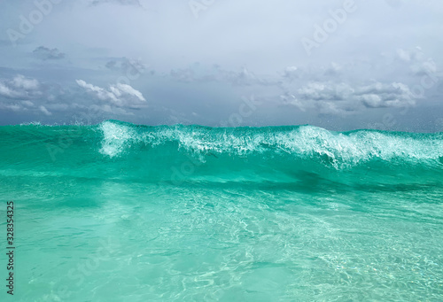 Turquoise water and big waves in Seychelles, La Digue beach. Travel and vacation