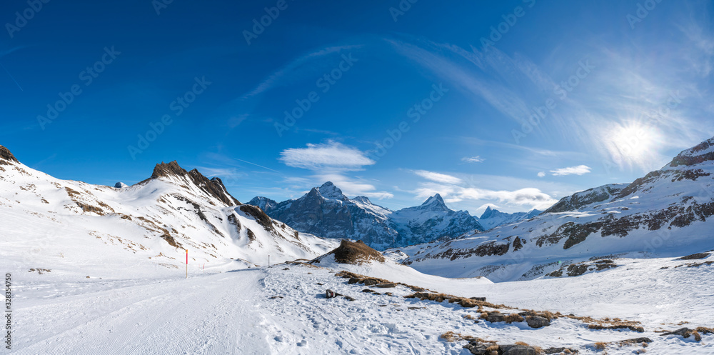 Wide parnoramic view of snow covered Swiss Alps from First mountain in Grindelwald ski resort, Switzerland