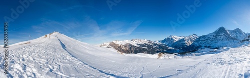 Wide parnoramic view of Swiss Alps in the winter at Mannlichen summit, Grindelwald, Switzerland photo