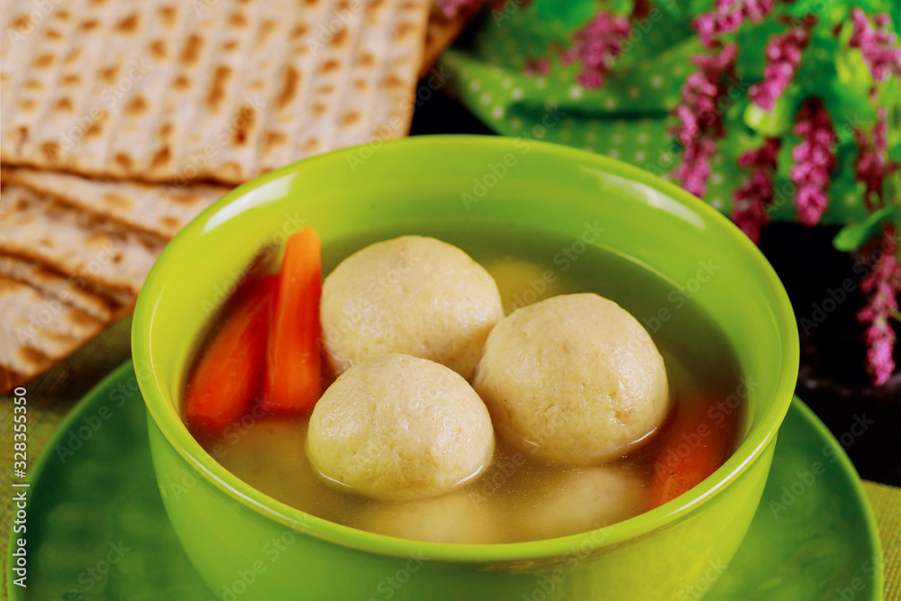 Delicious matzo ball soup with carrot and matzos bread. Close up. Delicious matzo ball soup with carrot and matzos bread. Close up.