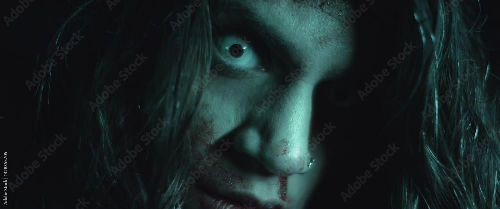 Terrifying creepy zombie woman with white eyes and scary look. Horror style shot