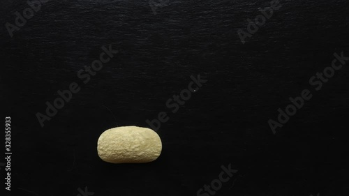 Stop motion animation of potato crisps disapearing from a slate
