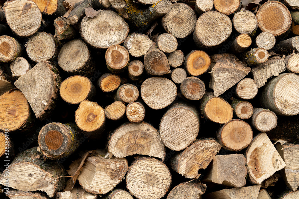 Cut wood lying on the stack. Background composed of chopped wood. Cut wood lying on the stack. Background composed of chopped wood.