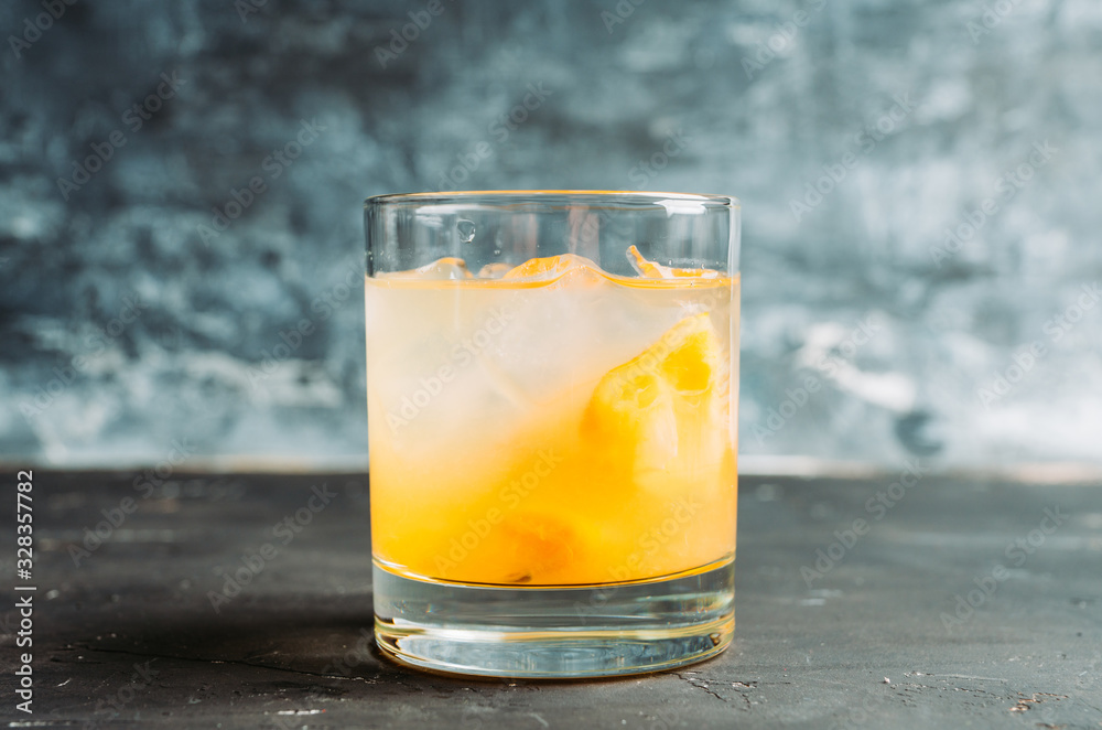 Old fahioned lemon beverage on the rustic background. Selective focus. Shallow depth of field.