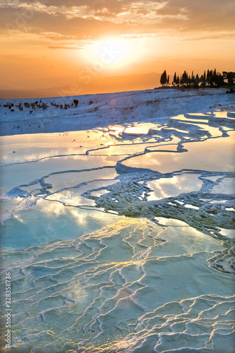 Carbonate travertines the natural pools during sunset, Pamukkale, Turkey - UNESCO HERITAGE photo