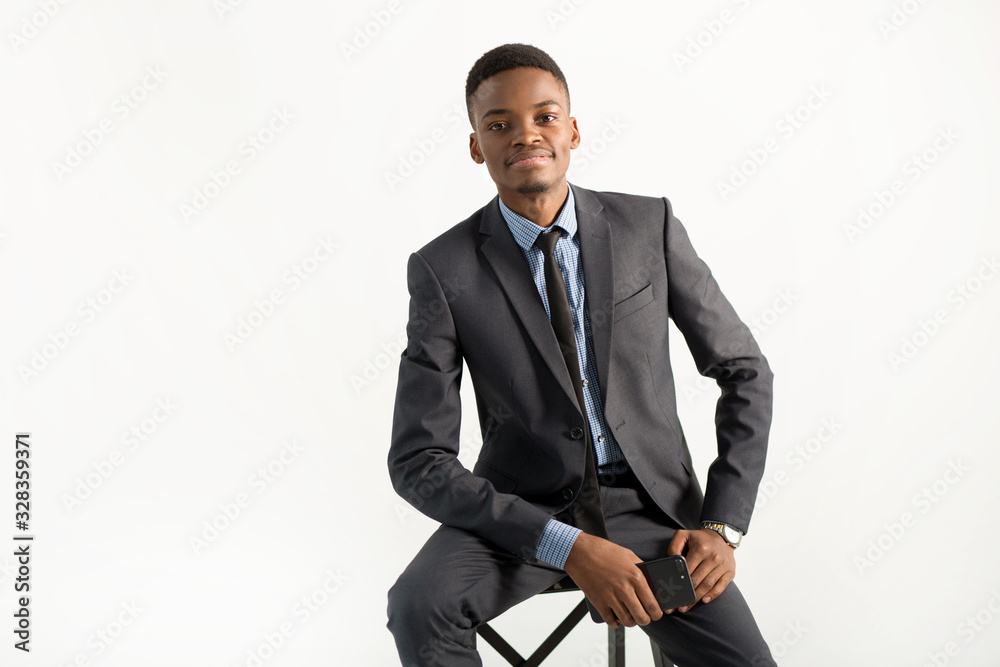 young handsome african man in a suit on a white background young handsome african man in a suit on a white background