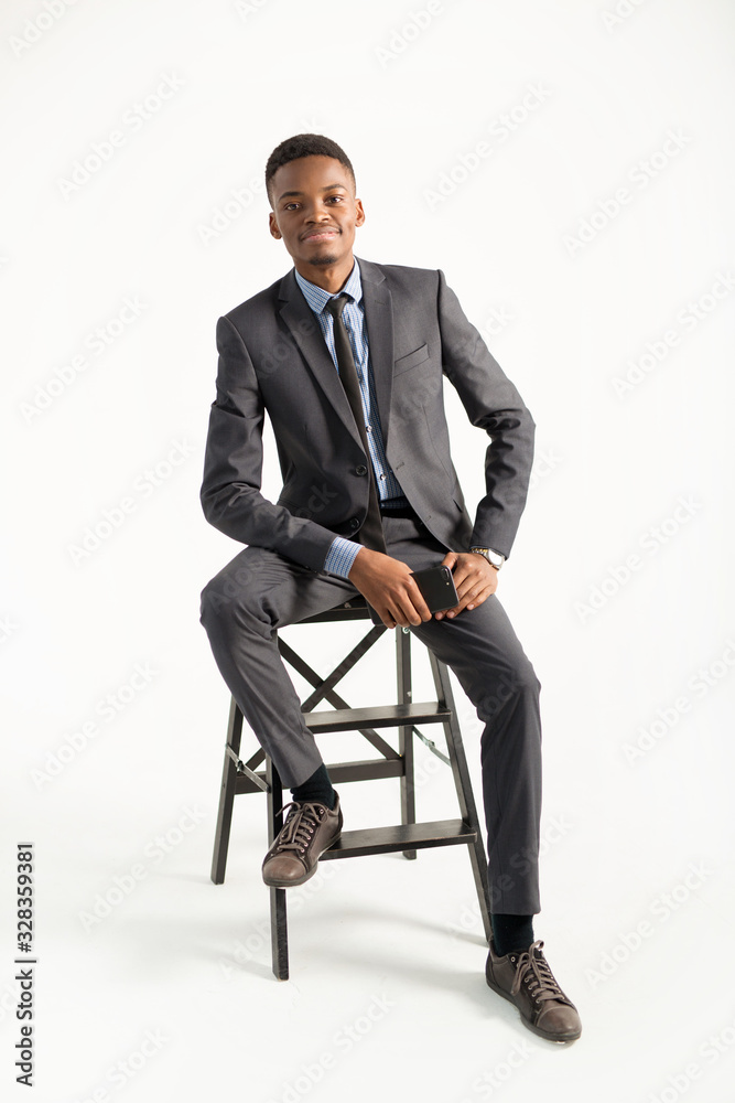 young handsome african man in a suit on a white background young handsome african man in a suit on a white background