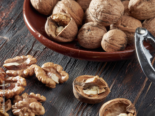 Walnut kernels on a dark table with a colored background