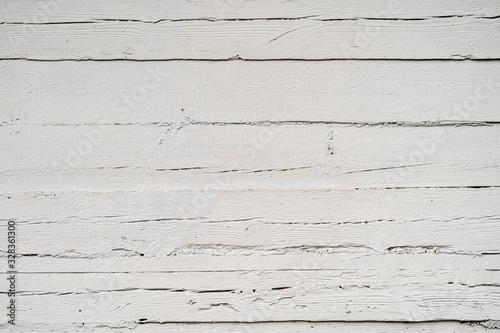 Texture od wooden planks painted with a white paint. Wall made of antique wood after century.